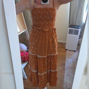peach colored floral maxi dress worn spaghetti straps
